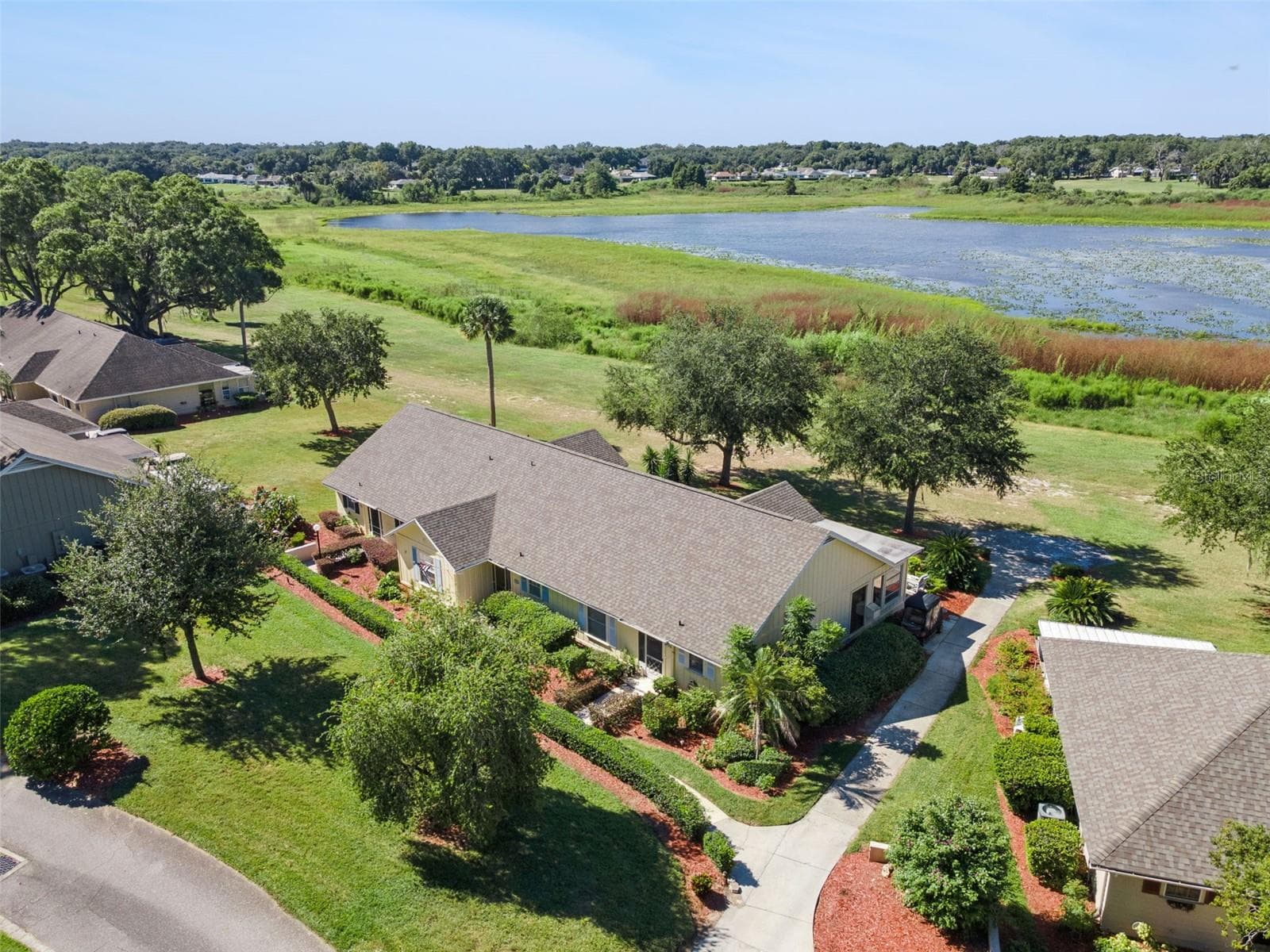 This home's architecture includes Bahamas-inspired color and roofline outside. - 1066 VILLA LN #63, APOPKA