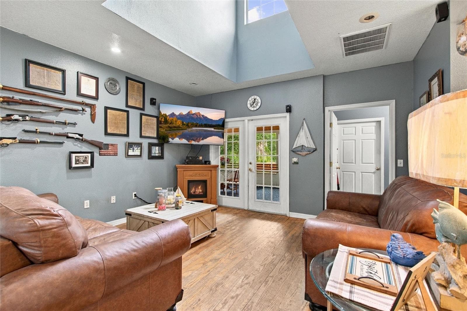 The living room has French doors that lead out to the rear patio. The doorway to the right leads into the laundry room. The closed door leads out to the garage. - 3850 GRANADA DR, INDIAN LAKE ESTATES