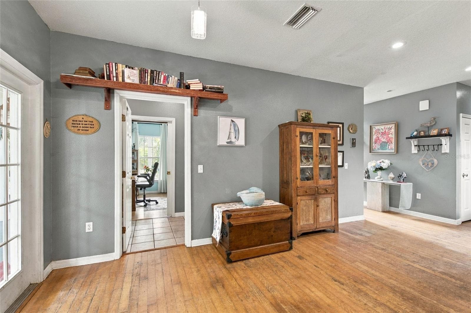 Looking at the dining area and also into the 4th bedroom from the kitchen. - 3850 GRANADA DR, INDIAN LAKE ESTATES