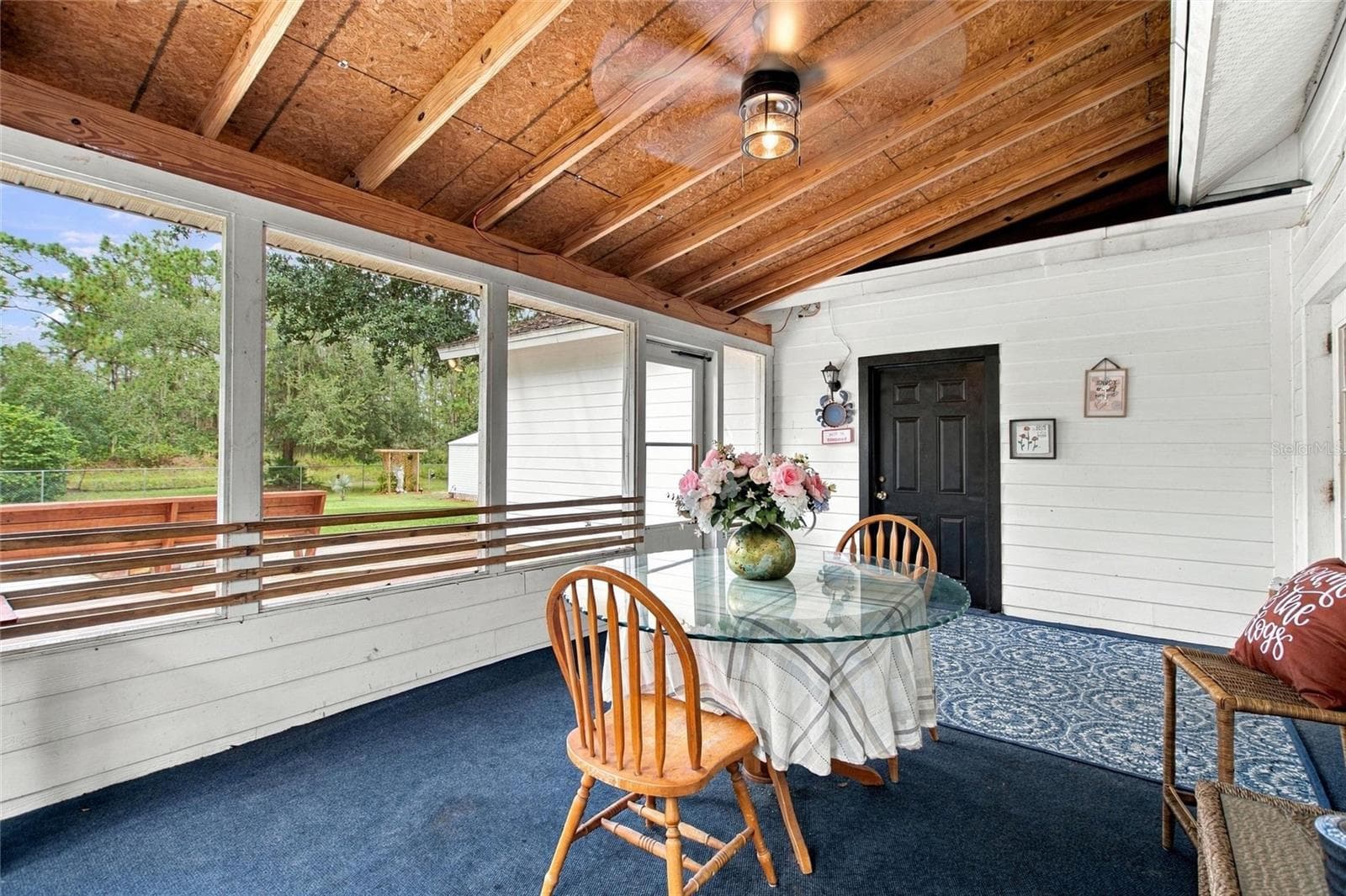 Enclosed patio. The black door leads into the garage. - 3850 GRANADA DR, INDIAN LAKE ESTATES