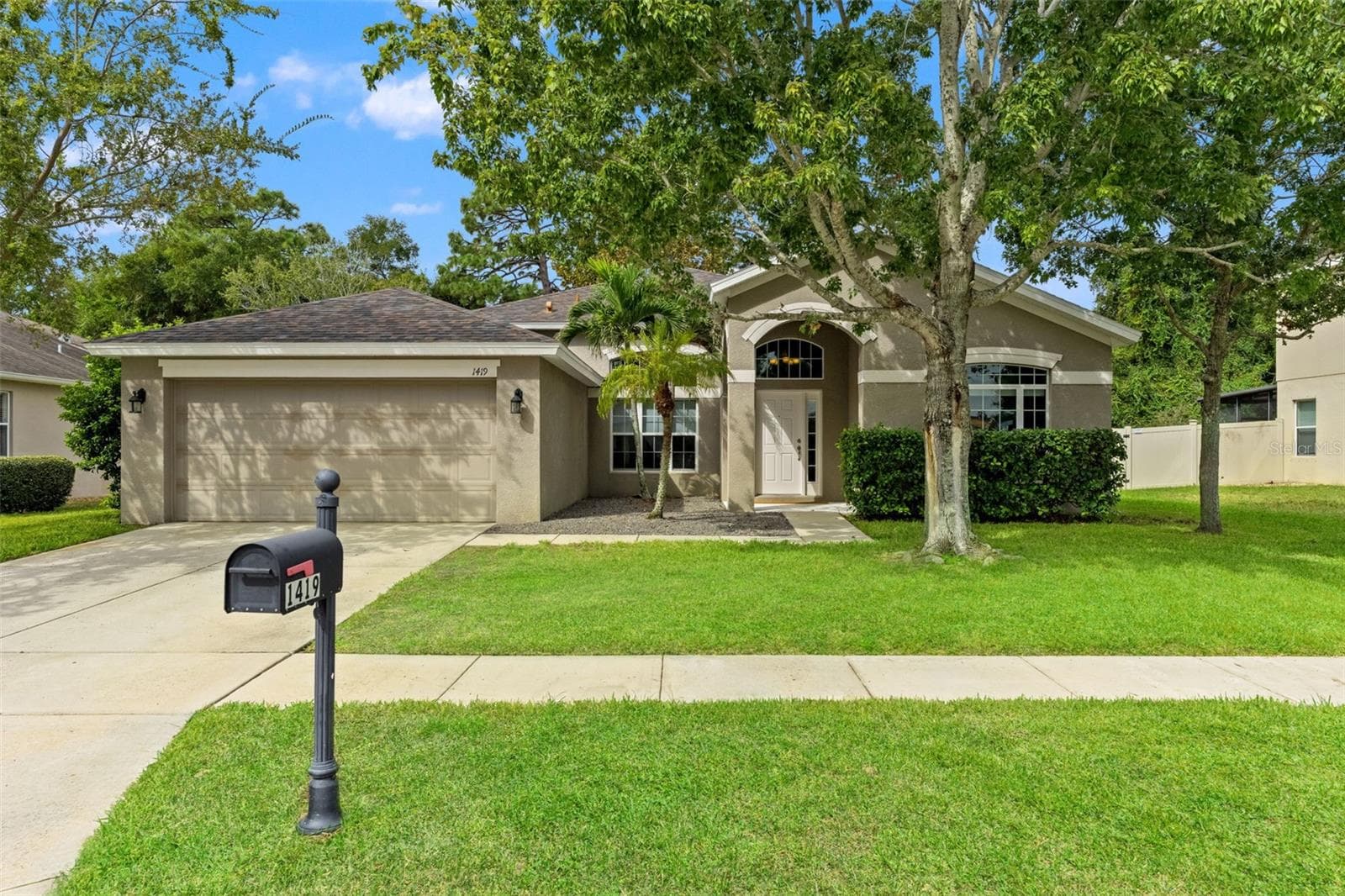 Set along a sidewalk-lined street in Gulfwinds, this 2,480-square-foot home offers plenty of room inside and out. - 1419 BLUE MARLIN BLVD, HOLIDAY