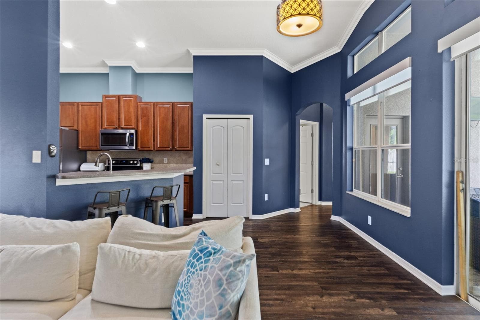 The kitchen and family room connect seamlessly, making it easy to cook, gather, and entertain without anyone feeling tucked away. - 1419 BLUE MARLIN BLVD, HOLIDAY