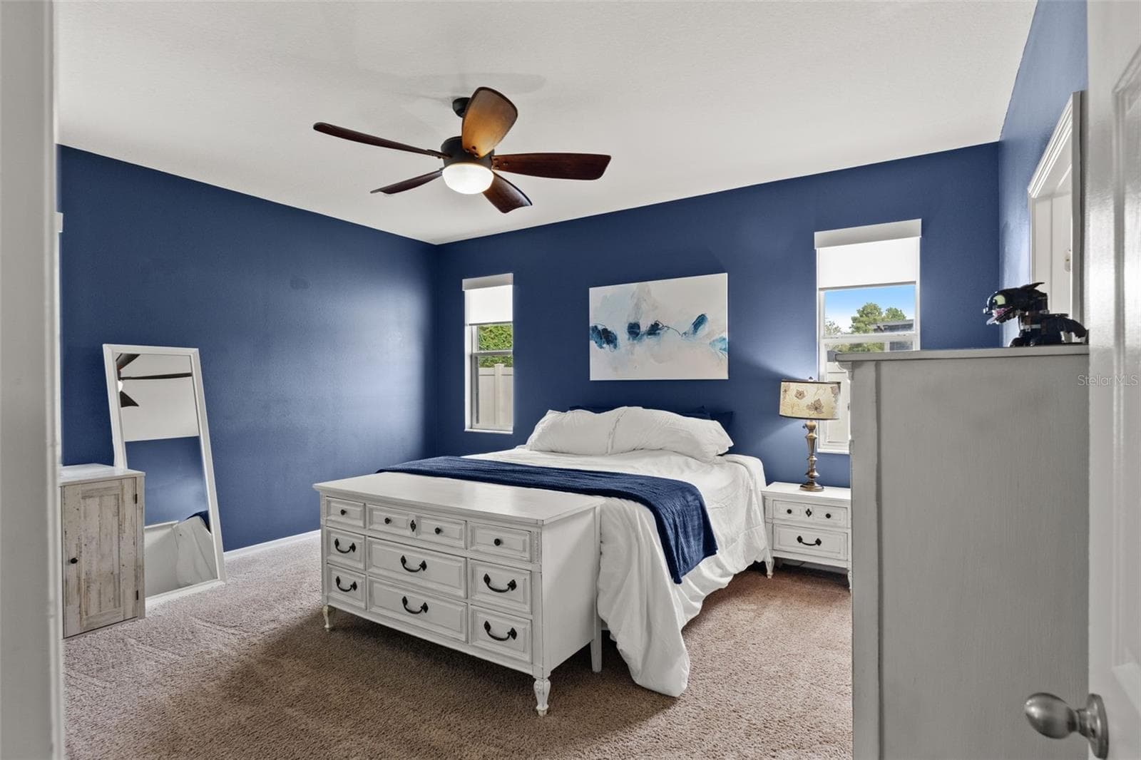 The spacious primary suite offers plenty of room for substantial furniture while maintaining a comfortable, uncluttered feel. - 1419 BLUE MARLIN BLVD, HOLIDAY