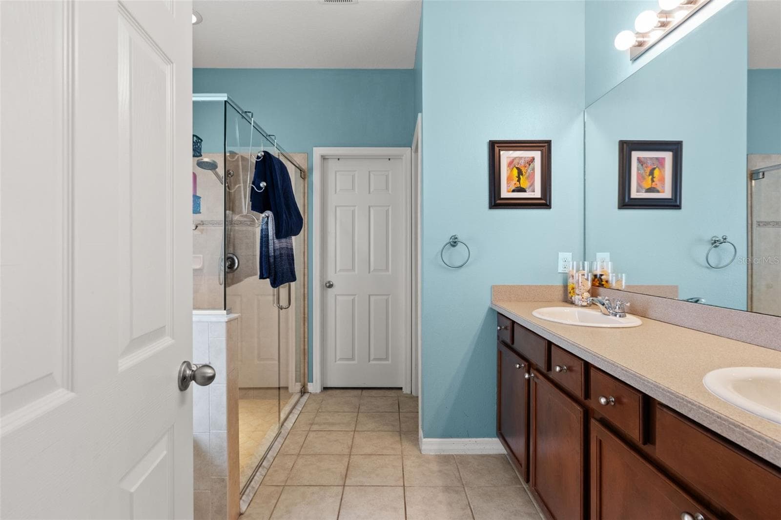 The primary bath features an extended dual-sink vanity with plenty of counter space and storage. - 1419 BLUE MARLIN BLVD, HOLIDAY