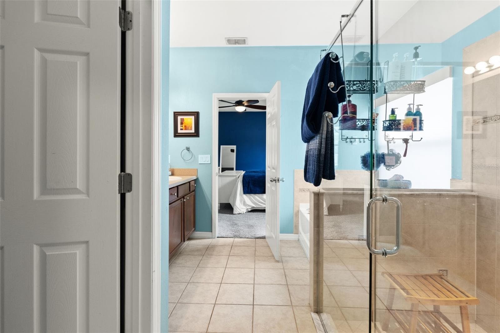 A separate glass-enclosed shower complements the primary bath’s spacious layout. - 1419 BLUE MARLIN BLVD, HOLIDAY