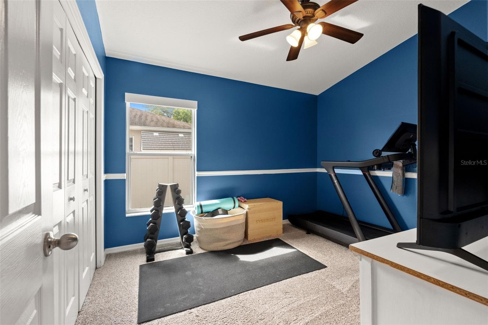 This additional bedroom is currently used as a home gym, showing just how adaptable the home’s extra rooms can be. - 1419 BLUE MARLIN BLVD, HOLIDAY