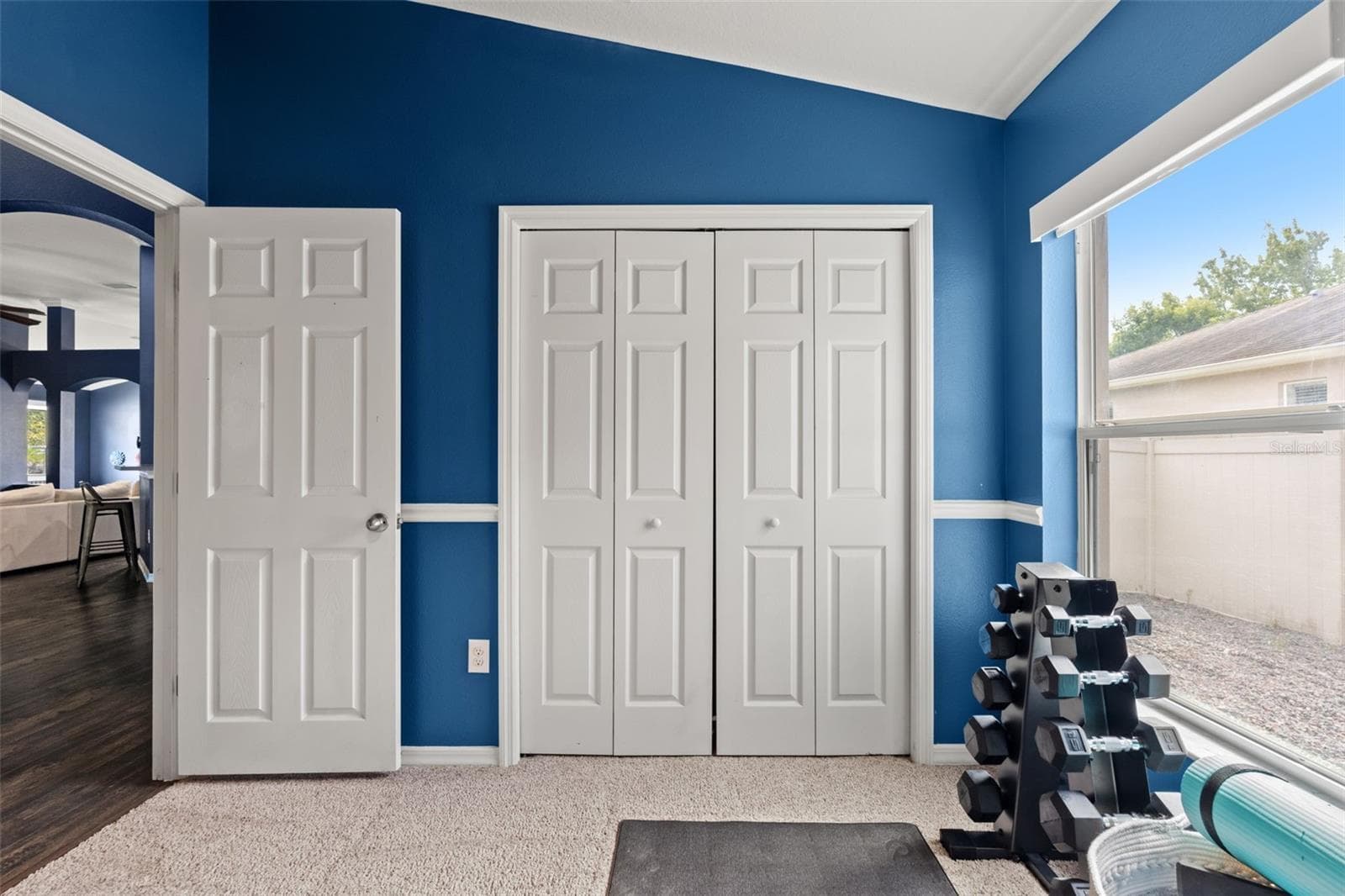 Natural light and a full closet make this flexible room equally well suited as a bedroom, fitness room, or hobby space. - 1419 BLUE MARLIN BLVD, HOLIDAY