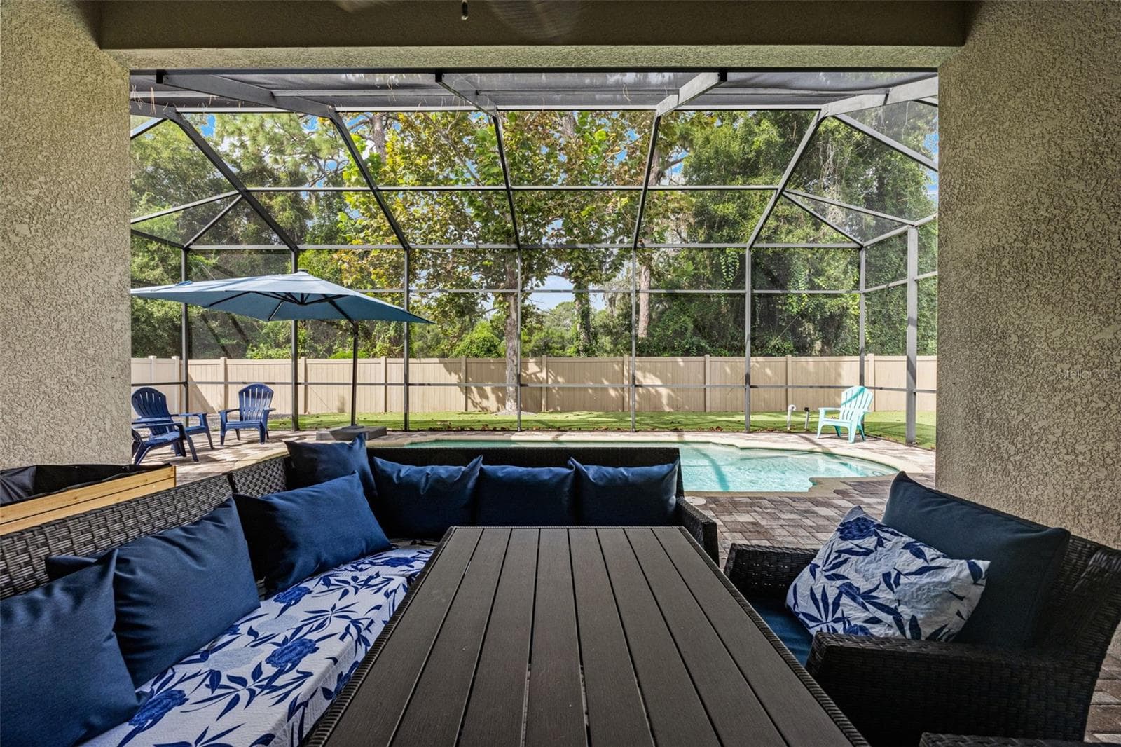 There’s plenty of room under cover for outdoor dining and lounging, creating a true extension of the home’s living space. - 1419 BLUE MARLIN BLVD, HOLIDAY