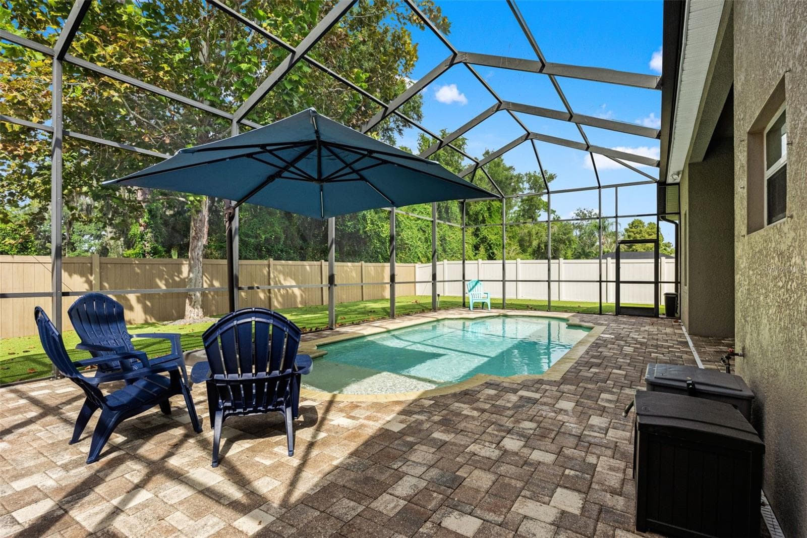 The pool deck offers multiple places to gather, whether you’re hosting friends or enjoying a quiet afternoon at home. - 1419 BLUE MARLIN BLVD, HOLIDAY