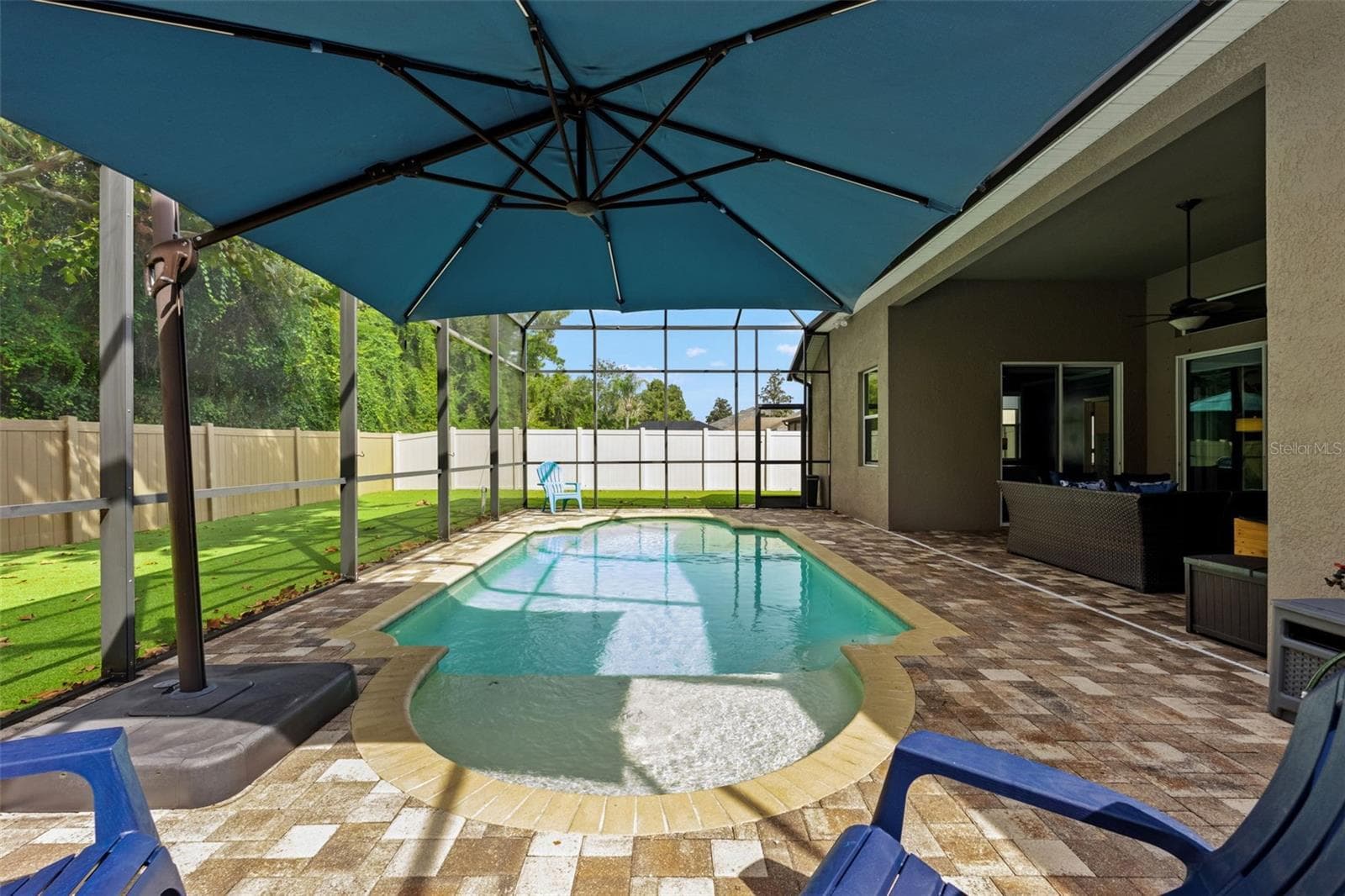 With no rear neighbors, the outdoor living area enjoys an added sense of privacy that’s hard to replicate. - 1419 BLUE MARLIN BLVD, HOLIDAY