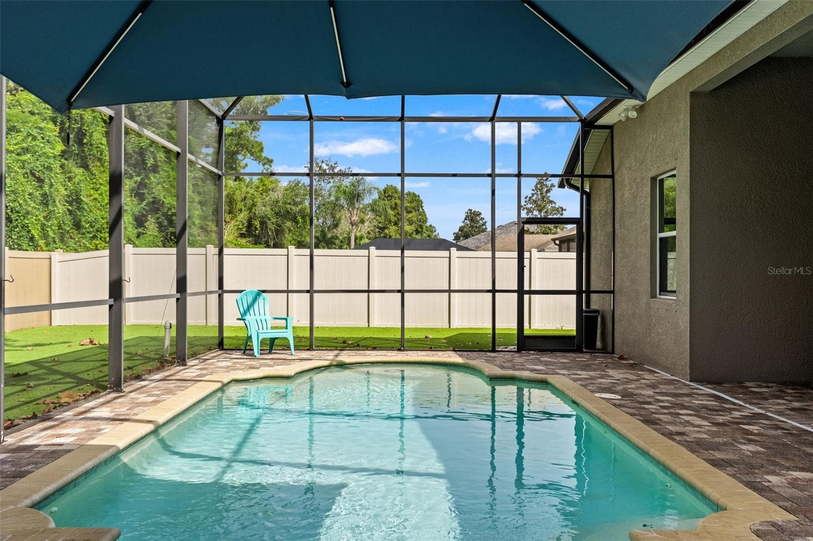 A screened saltwater pool, covered lanai, and private setting come together for the kind of backyard Florida living is all about. - 1419 BLUE MARLIN BLVD, HOLIDAY