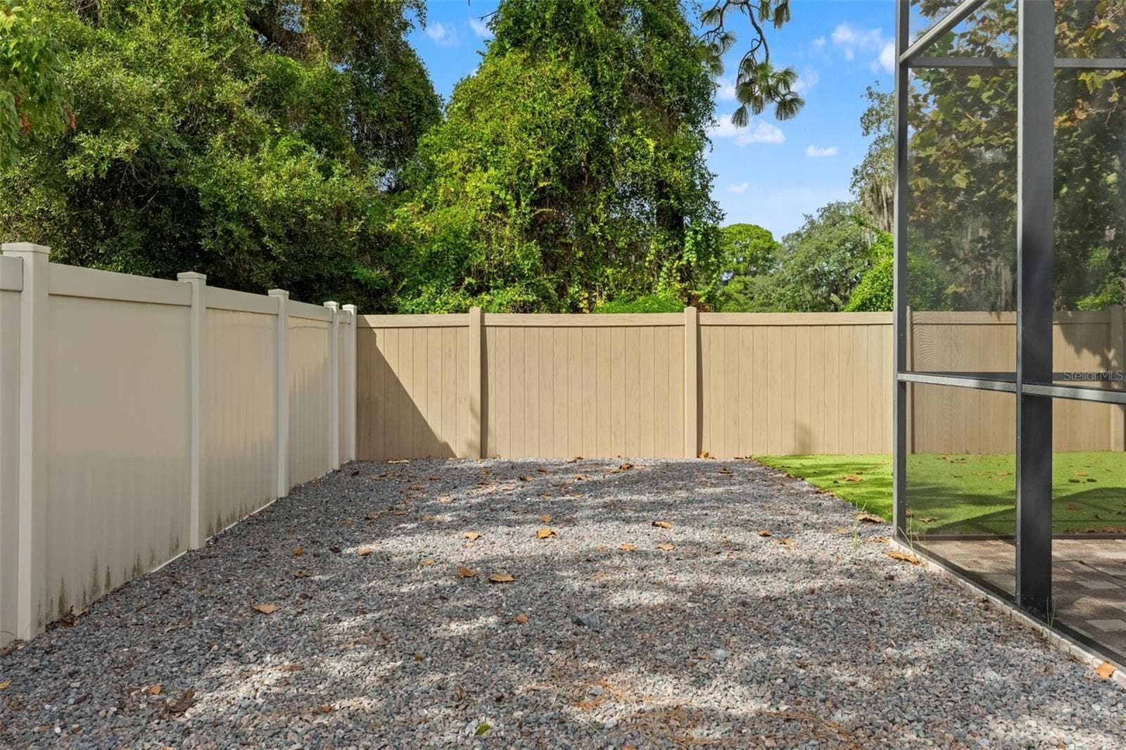 This low-maintenance side area adds another practical outdoor zone alongside the screened pool enclosure. - 1419 BLUE MARLIN BLVD, HOLIDAY