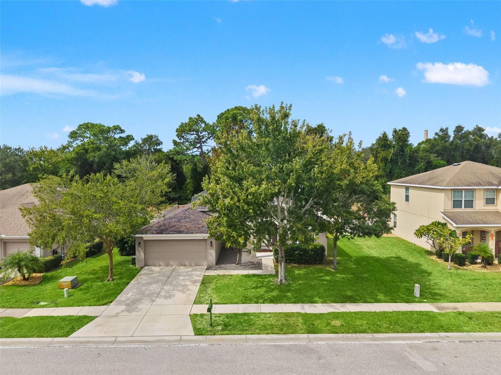 From above, the home’s single-story design, mature landscaping, and established Gulfwinds setting come into view. - 1419 BLUE MARLIN BLVD, HOLIDAY