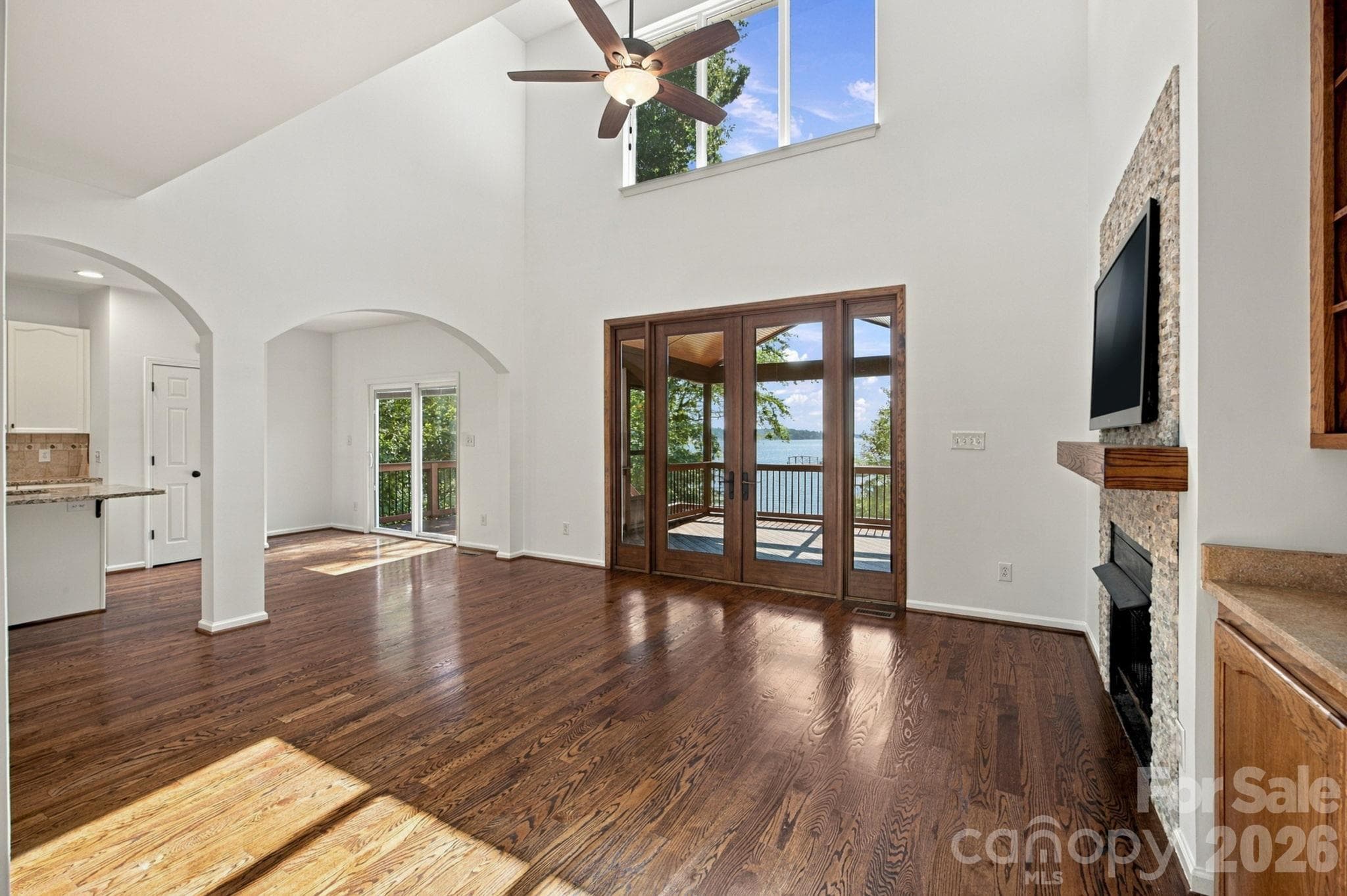 Large French doors open the room to the screened-in deck and beautiful lakeview staged - 3774 Gordon Road, Terrell