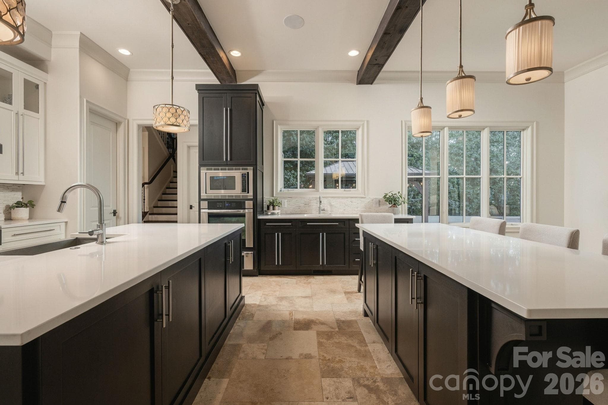This gorgeous kitchen has  a double island with 3 sinks, beautiful cabinetry, beams, sub zero refrigerator, incredible wet bar and SO much more! - 21215 Senlac Lane, Cornelius