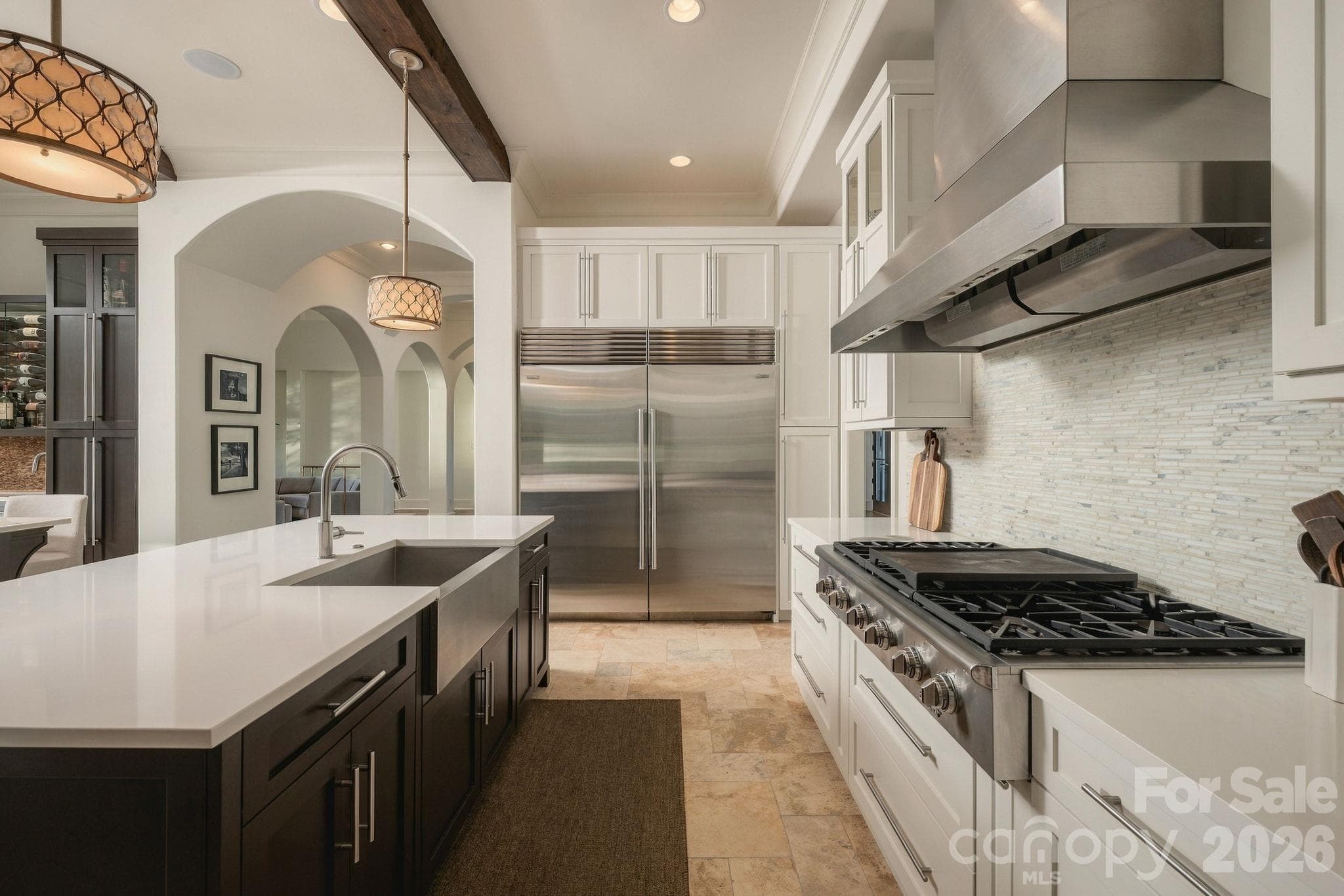 This gorgeous kitchen has  a double island with 3 sinks, beautiful cabinetry, beams, sub zero refrigerator, incredible wet bar and SO much more! - 21215 Senlac Lane, Cornelius