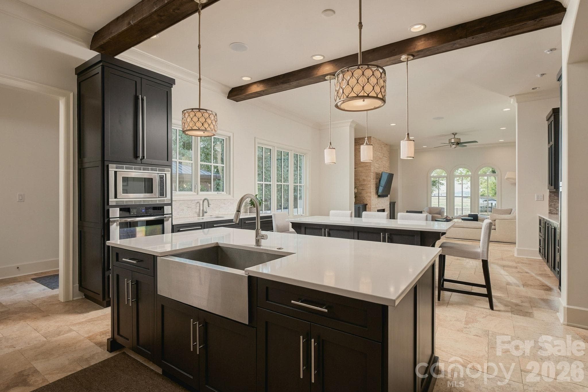 This goregous kitchen has  a double island with 3 sinks, beautiful cabinetry, beams, sub zero refrigerator, incredible wet bar and SO much more! - 21215 Senlac Lane, Cornelius