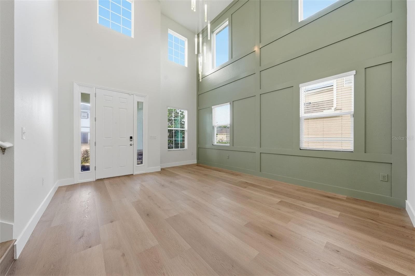 Two-story foyer with new statement chandelier - 5839 SW 86TH ST, OCALA