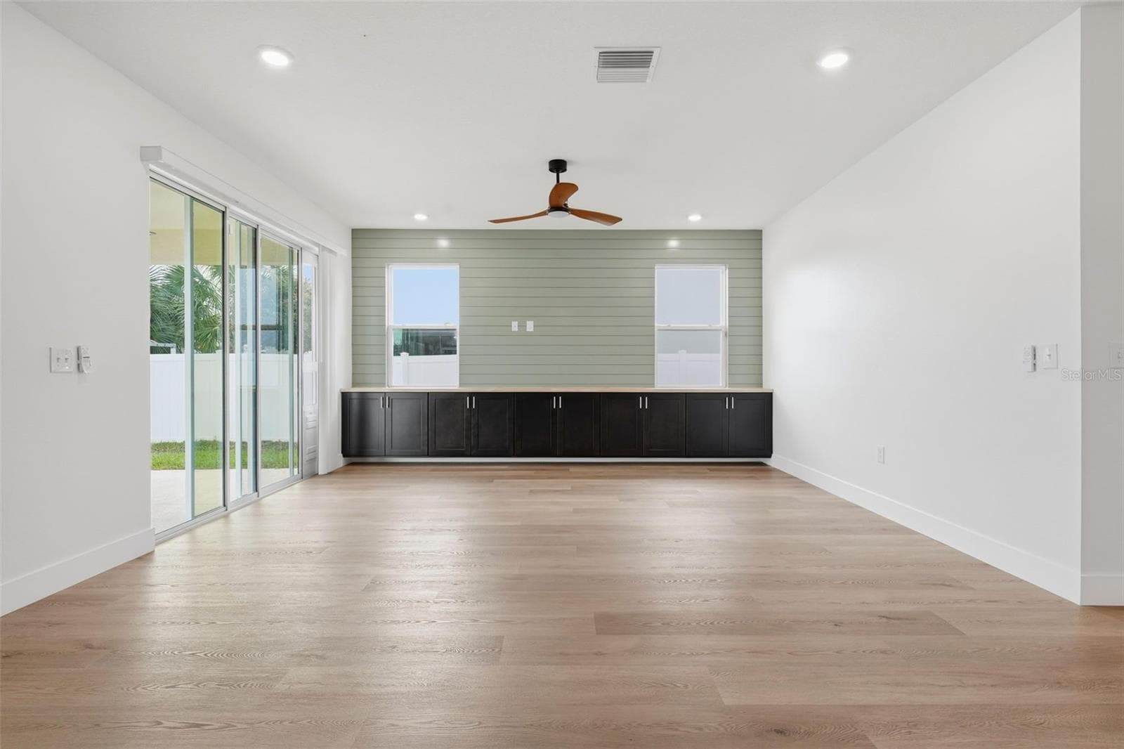 Living room with sliders to the covered lanai - 5839 SW 86TH ST, OCALA