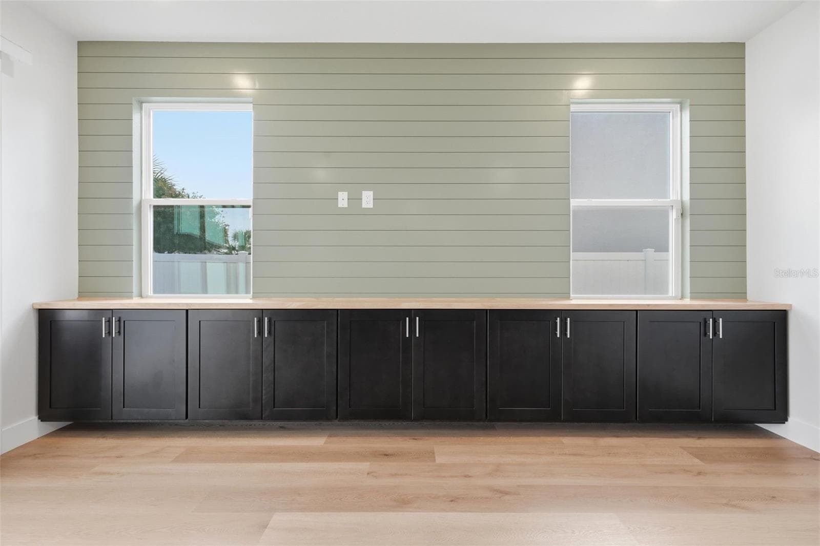 Custom built-ins and shiplap accent wall in the living room - 5839 SW 86TH ST, OCALA