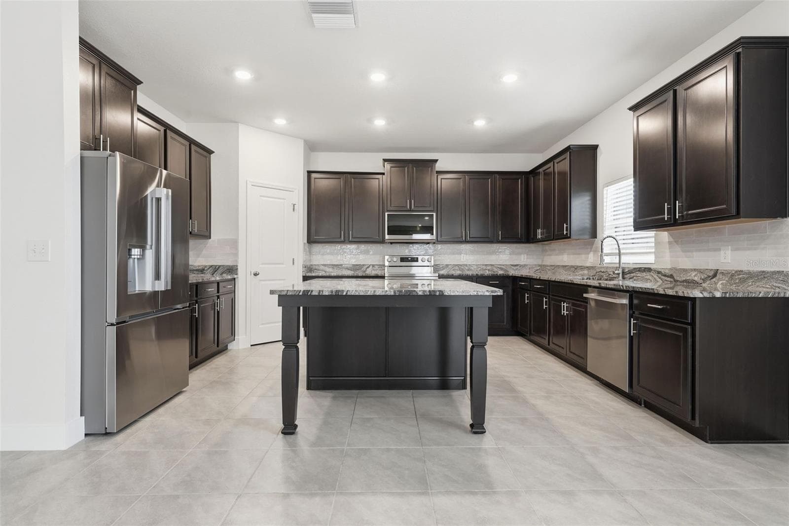 Kitchen with brand-new LG stainless steel appliances and walk-in pantry - 5839 SW 86TH ST, OCALA