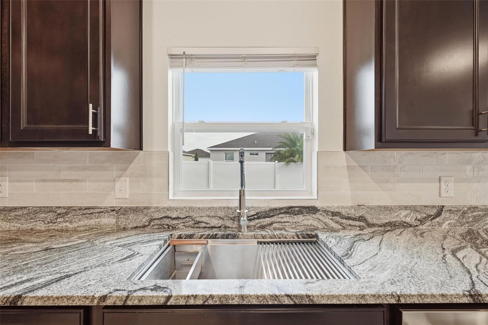 Large single basin, stainless steel sink with Granite counters and new tile backsplash - 5839 SW 86TH ST, OCALA