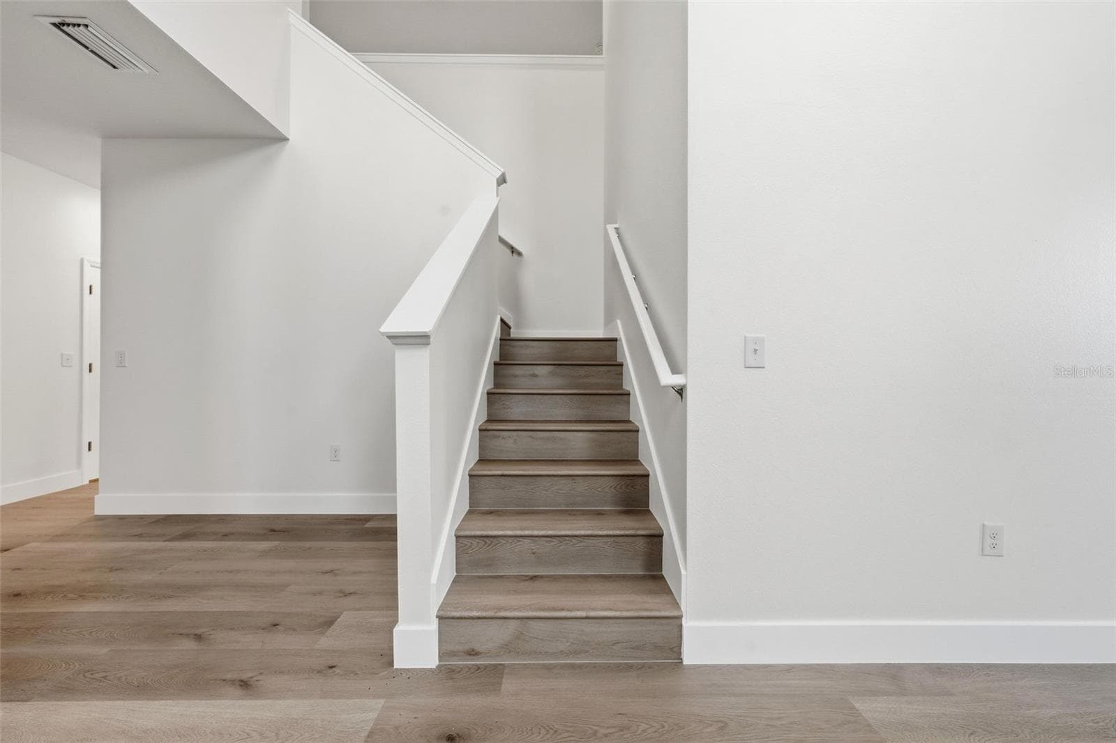 Staircase with new LVP and fresh paint - 5839 SW 86TH ST, OCALA