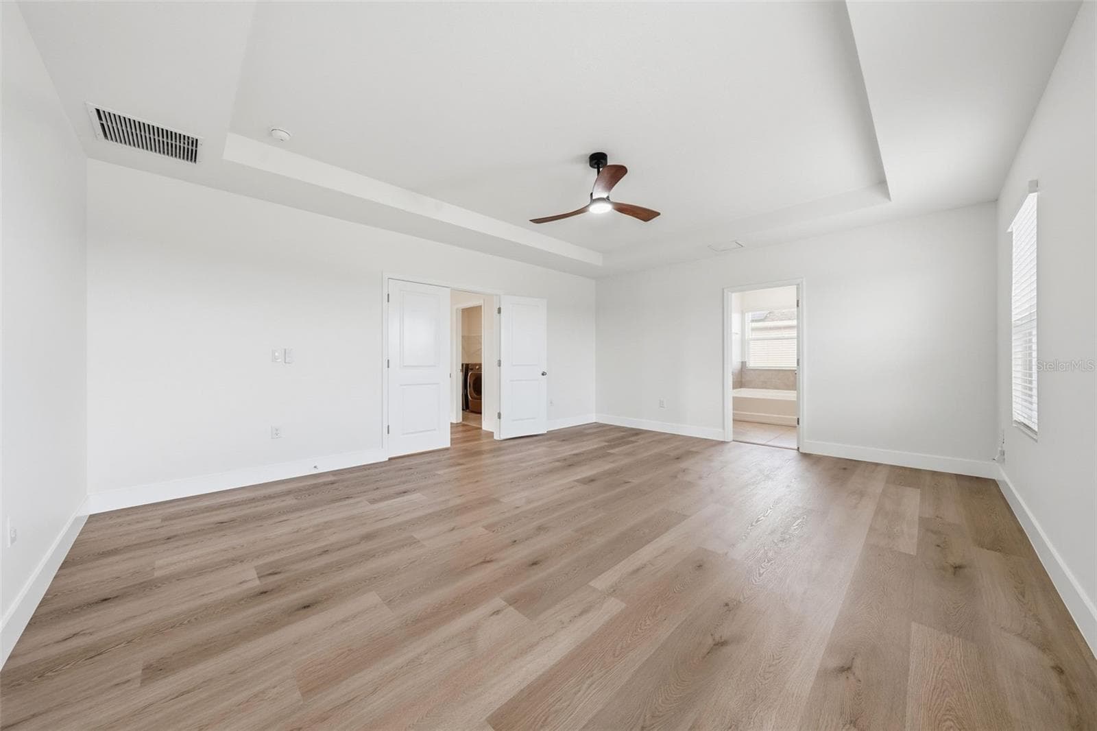Primary bedroom with french door entry and room for a sitting area - 5839 SW 86TH ST, OCALA