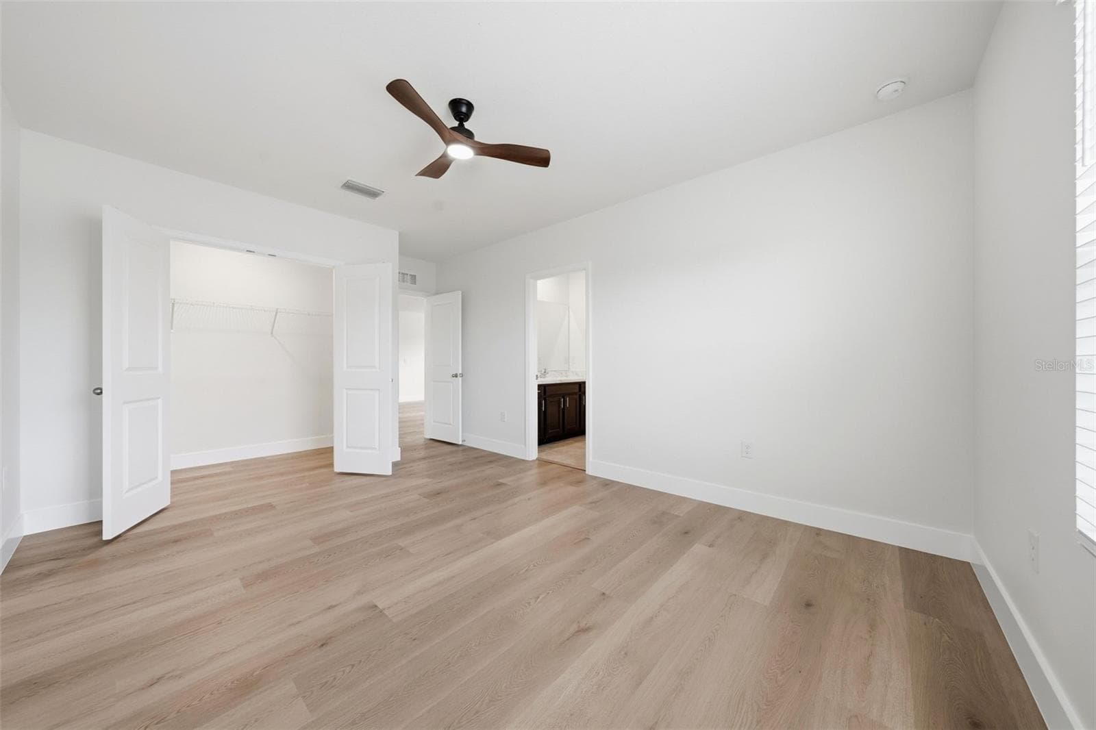 Upstairs 2nd bedroom with new LVP and ceiling fan - 5839 SW 86TH ST, OCALA