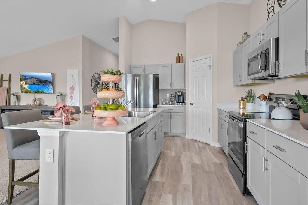 Kitchen opens to living room and dining room - 5945 SLATE ROCK DR, LAKELAND