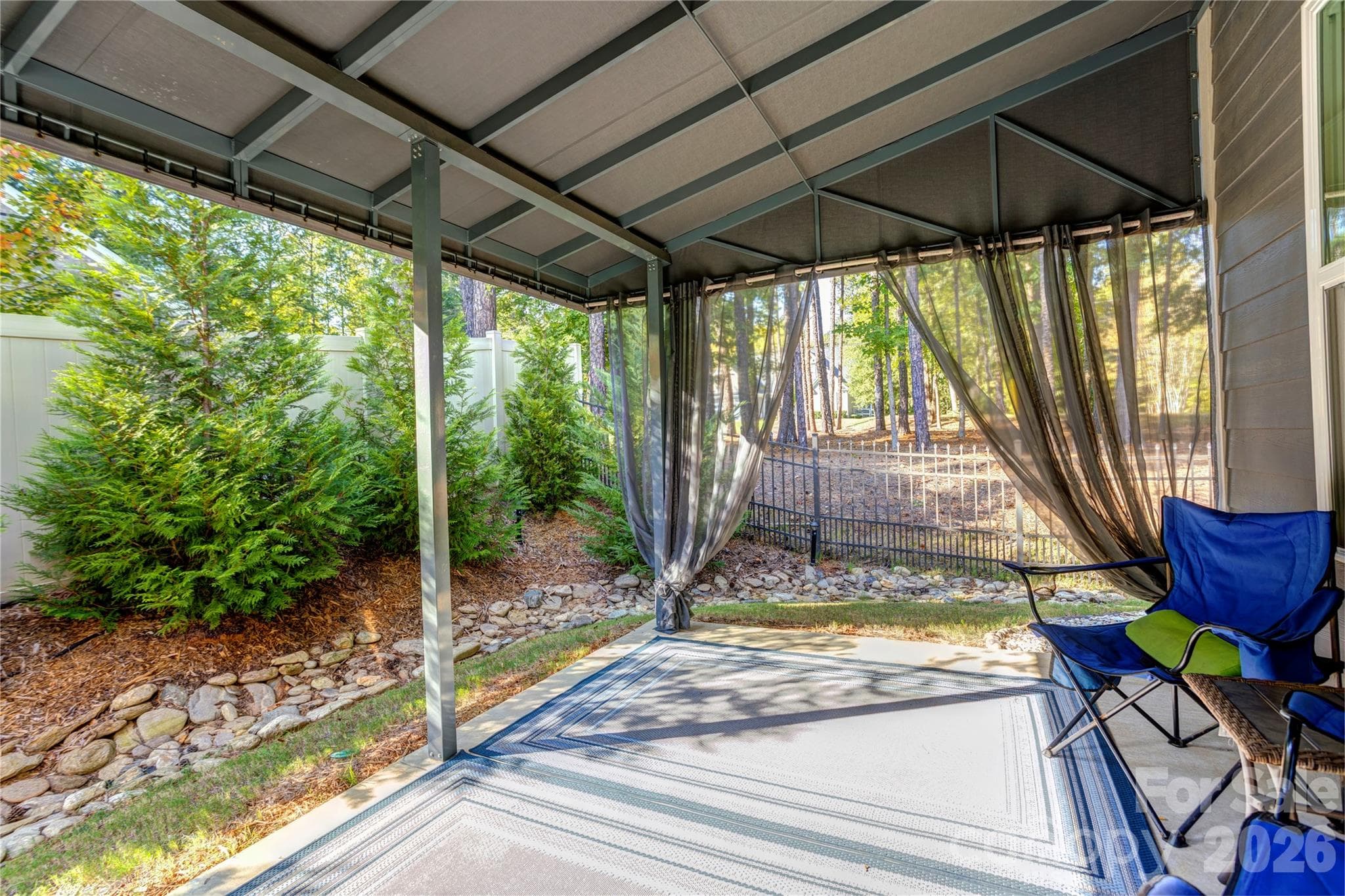 A covered back patio with an awning for shaded outdoor dining and relaxing. - 158 Fulworth Drive NW, Concord