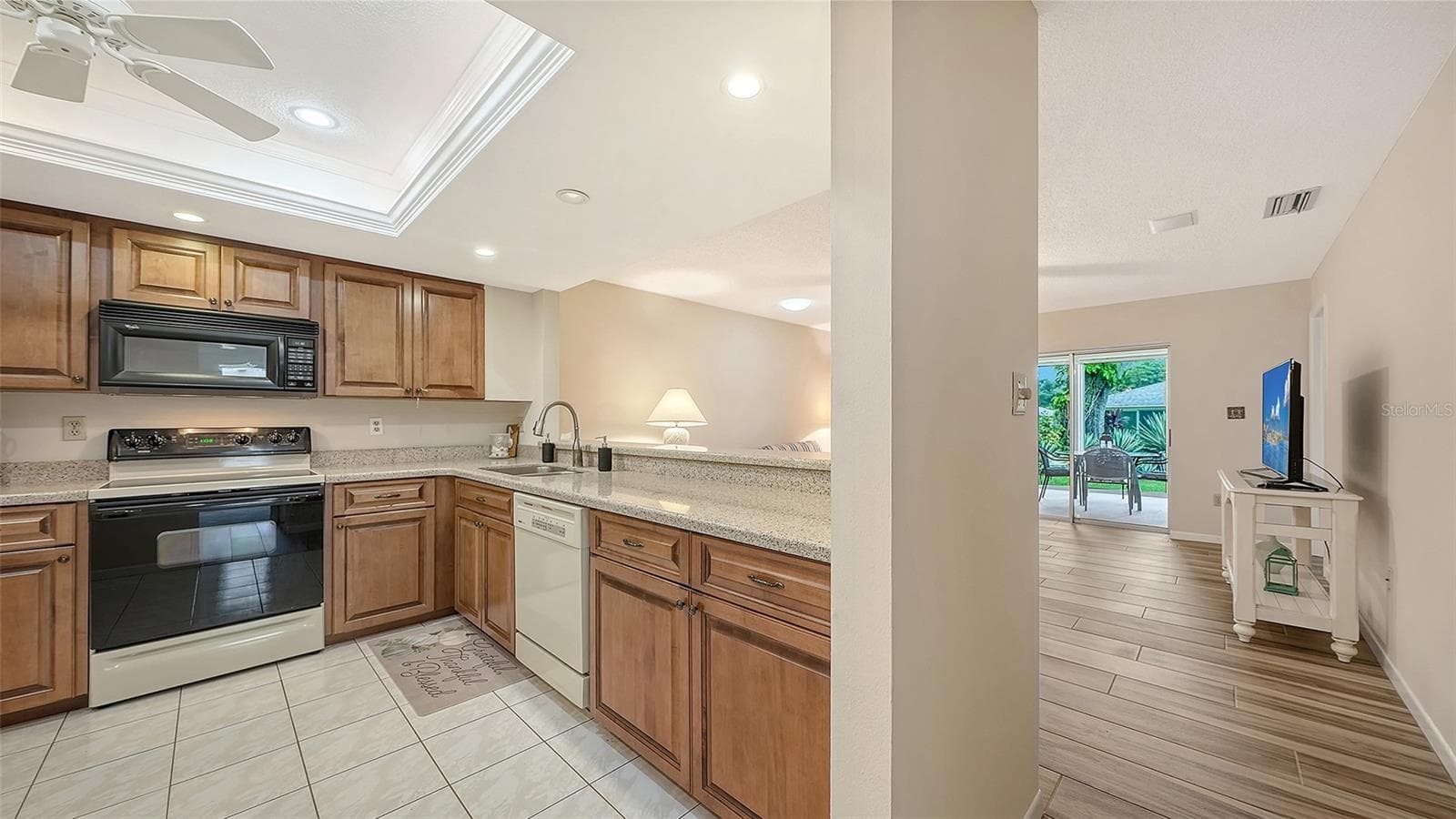 Wood cabinets with granite counters in the kitchen. - 4207 BOWLING GREEN CIR, SARASOTA