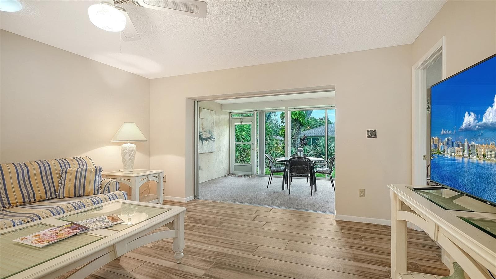 The family room connects to the lanai through the sliders that pocket. - 4207 BOWLING GREEN CIR, SARASOTA