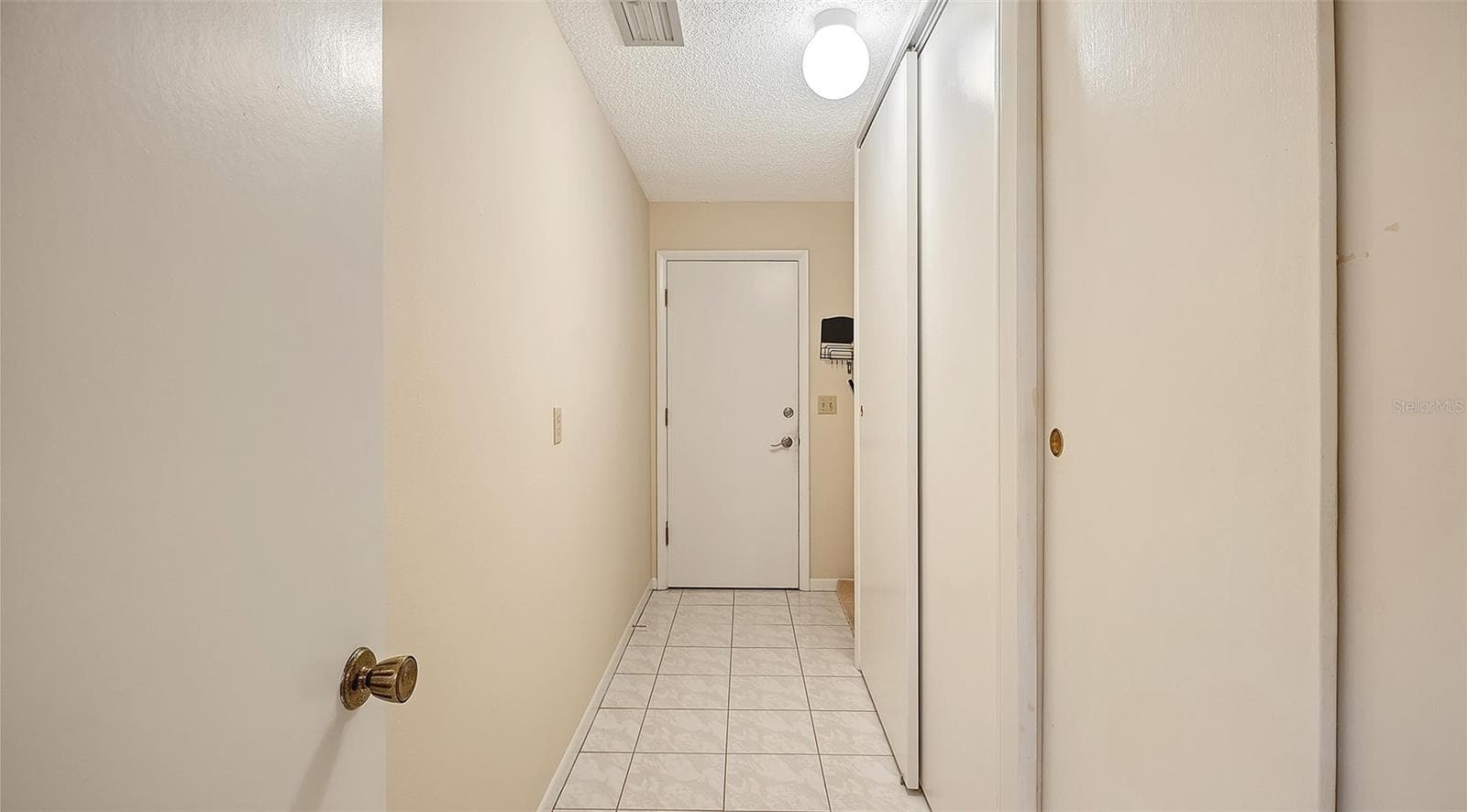 The hall from the kitchen to the garage has plenty of extra closet space. - 4207 BOWLING GREEN CIR, SARASOTA