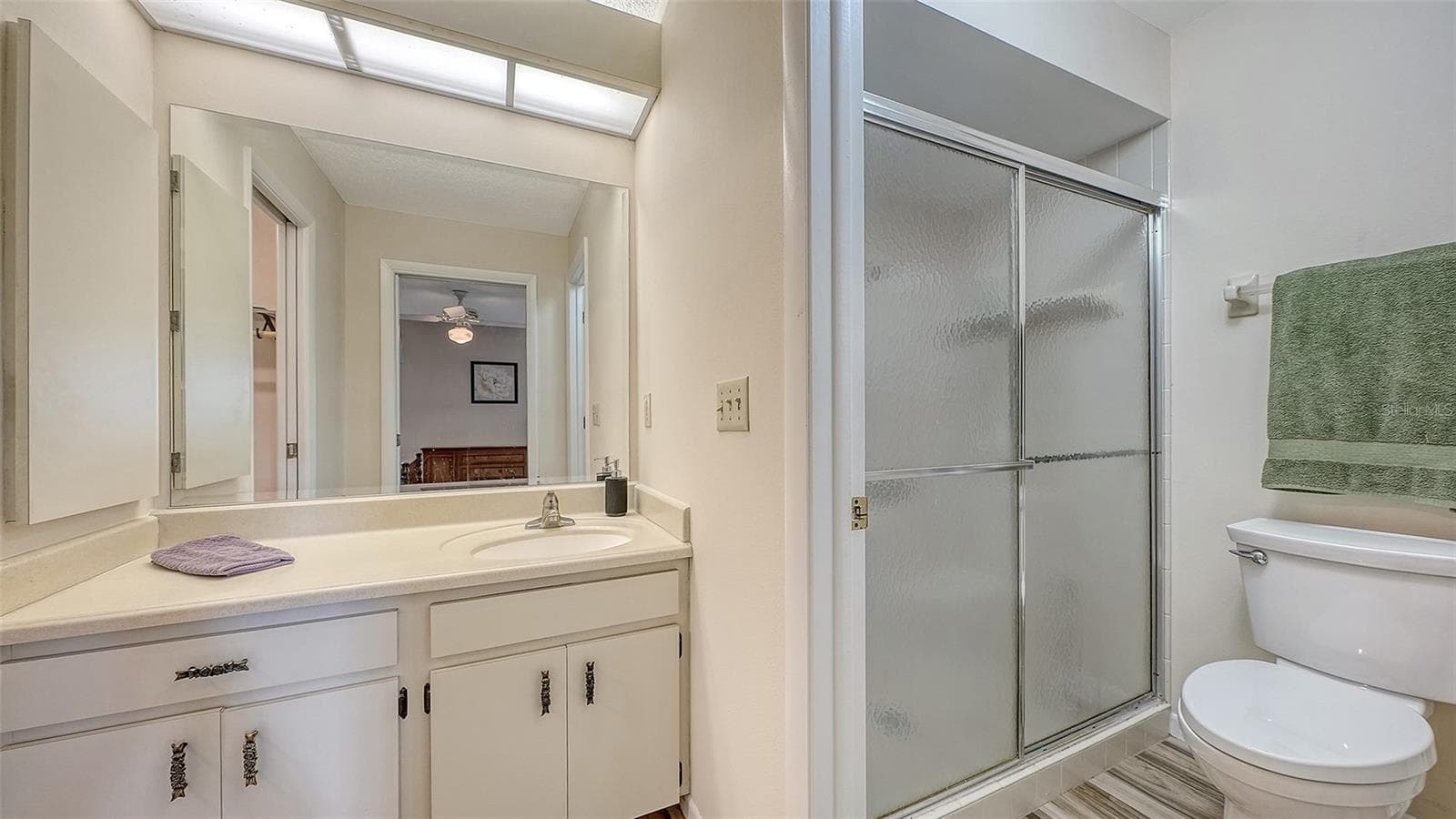 The main bath has a walk-in shower. - 4207 BOWLING GREEN CIR, SARASOTA