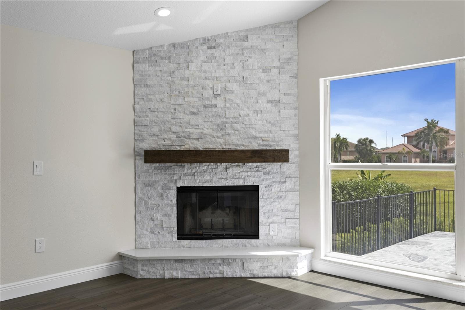Beautiful wood-burning fireplace with elegant mantel and tile surround - a charming touch of character. - 6402 RUBIA CIR, APOLLO BEACH