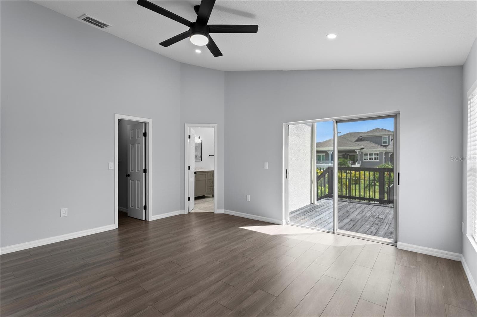 The primary bedroom features sliding doors that lead to the private deck. - 6402 RUBIA CIR, APOLLO BEACH