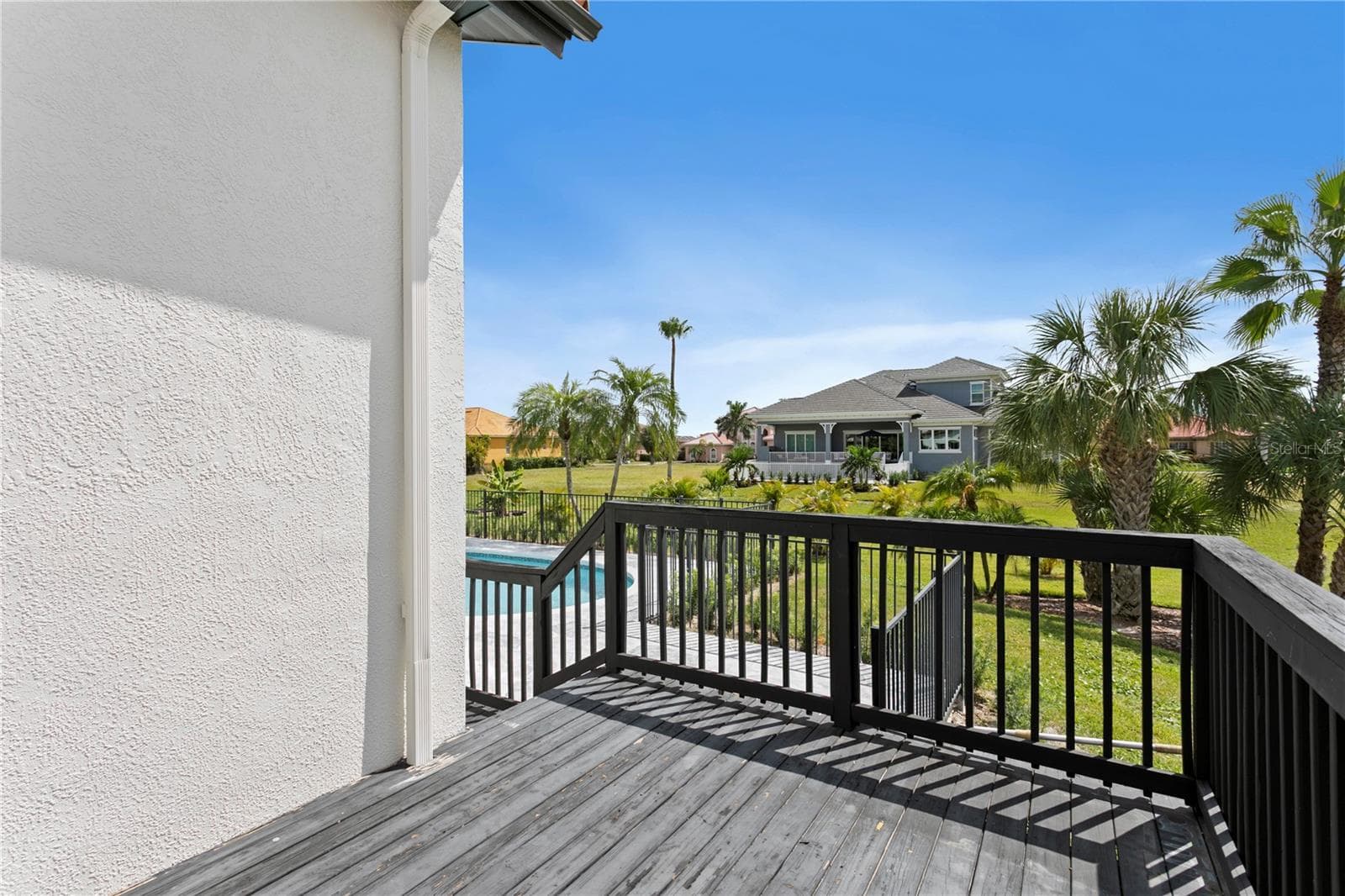 Sliding doors off the primary bedroom lead to this private deck. A perfect spot to relax. - 6402 RUBIA CIR, APOLLO BEACH
