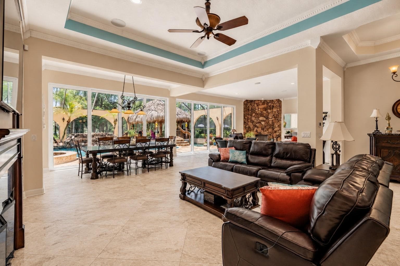Expansive Family Room with view of Beautiful Pool Oasis, Backyard and Lake - 21246 QUIET HAVEN CT, LAND O LAKES