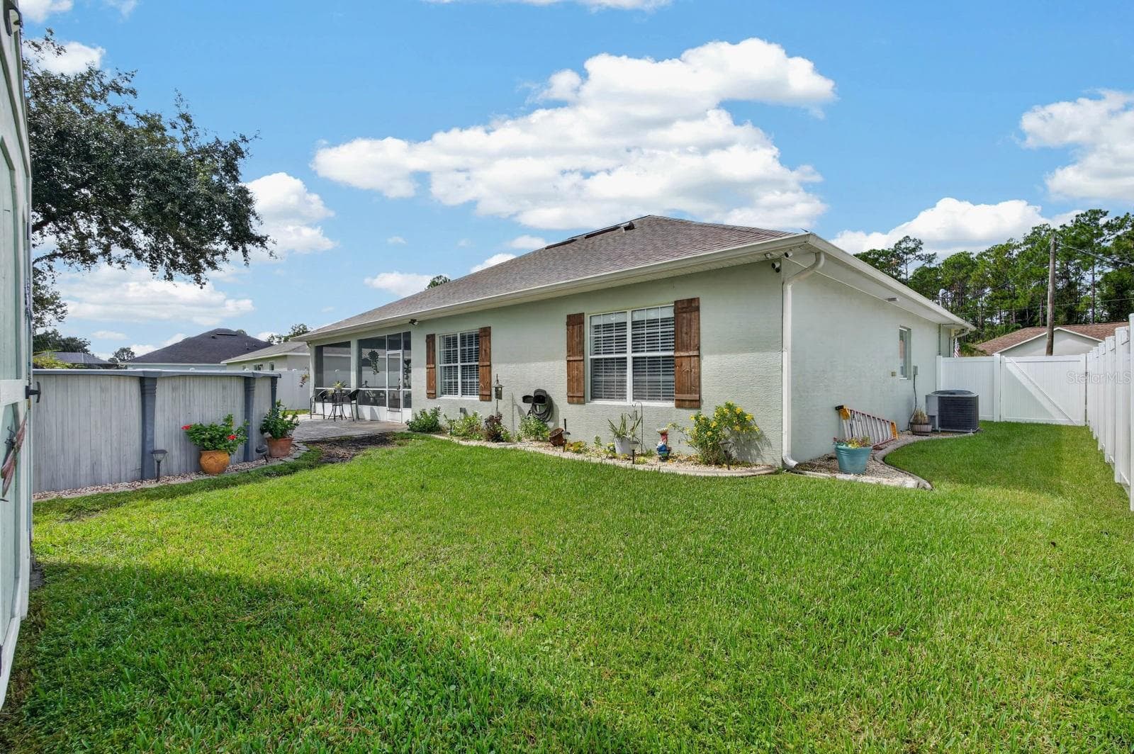 concrete landscape border and beautiful decorative shutters enhance exterior appeal! - 72 KARAS TRL, PALM COAST