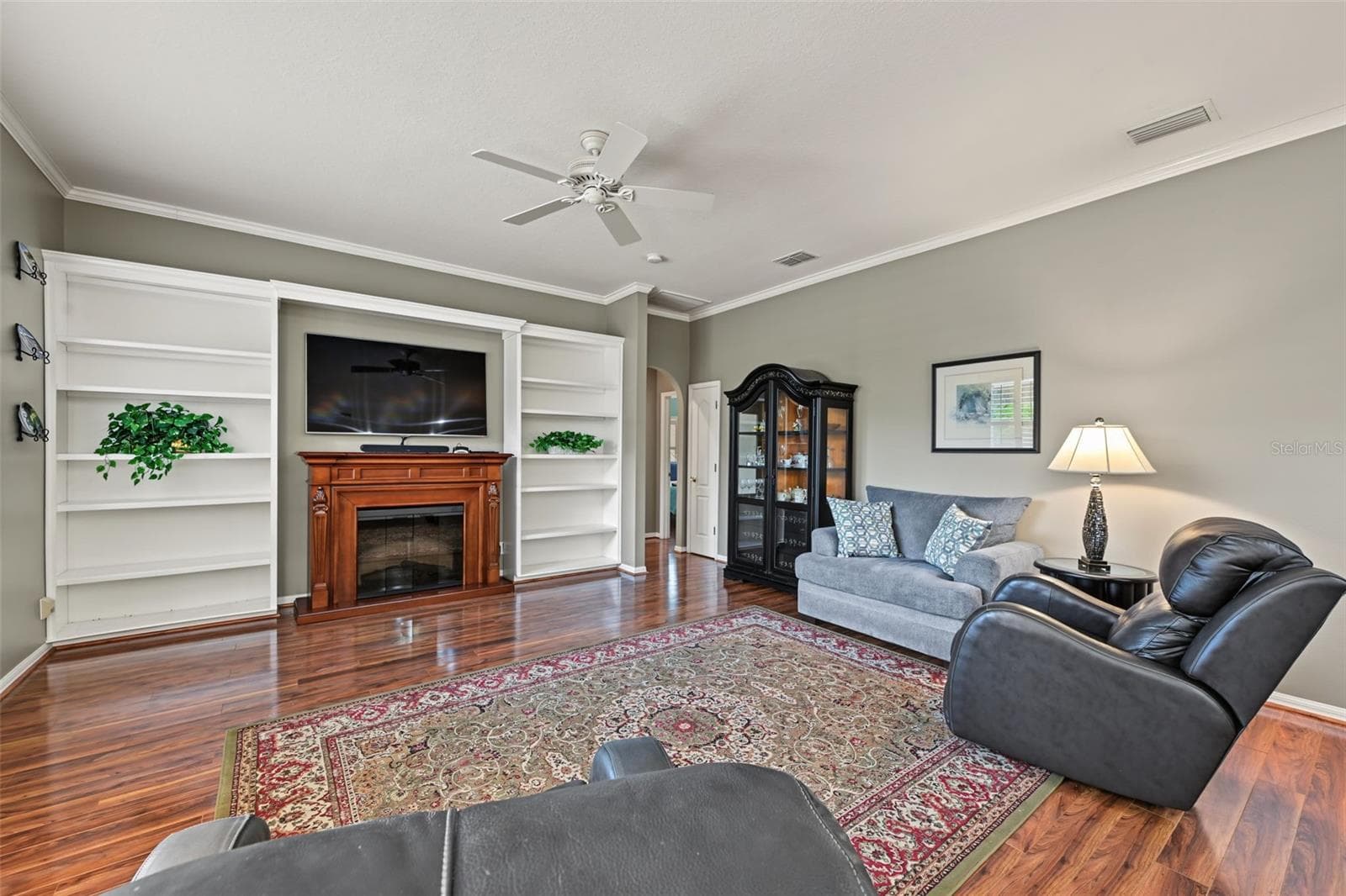 Family room with freestanding electric fireplace - 1028 HAGEN DR, NEW PORT RICHEY