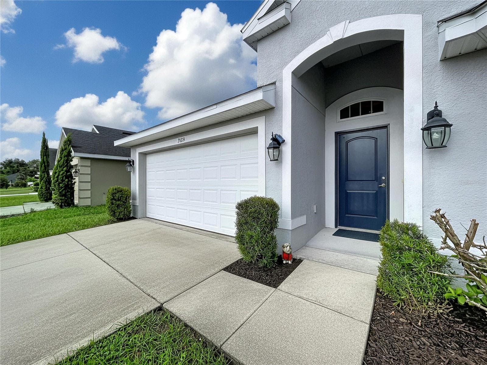 FRONT DOOR WITH CONCRETE ACCESSIBILITY ENTRANCE - 7029 WIREVINE DR, BROOKSVILLE