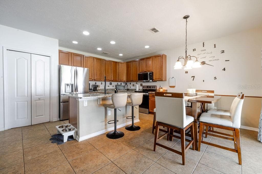 Kitchen with large island and dining area - 252 SHERRI LEE LN, DELAND