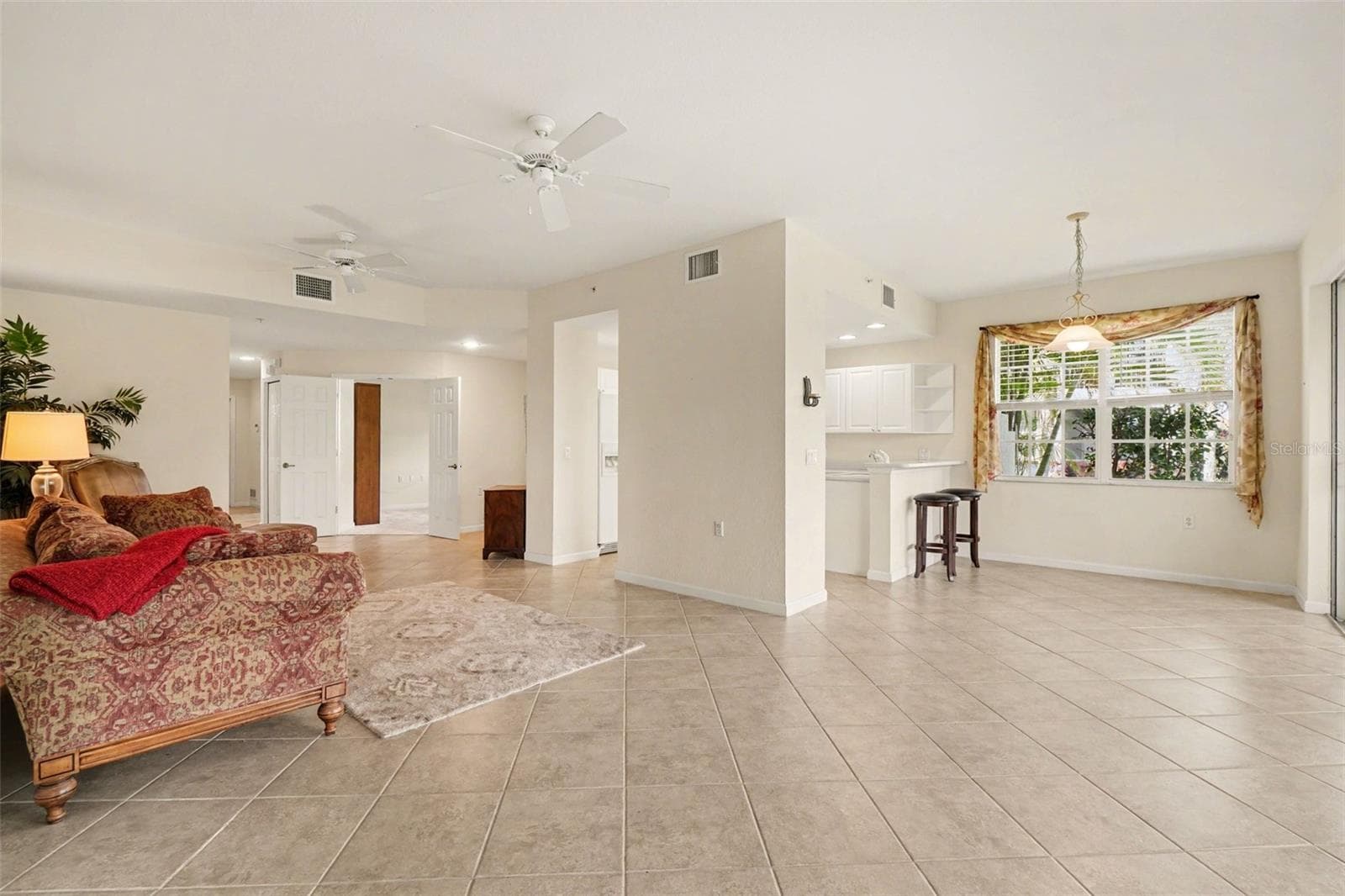 Dining room has a view of lanai and preserve through the sliding glass doors with a wall windows providing a bright and cheering atmosphere - 4683 CLUB DR #101, PORT CHARLOTTE