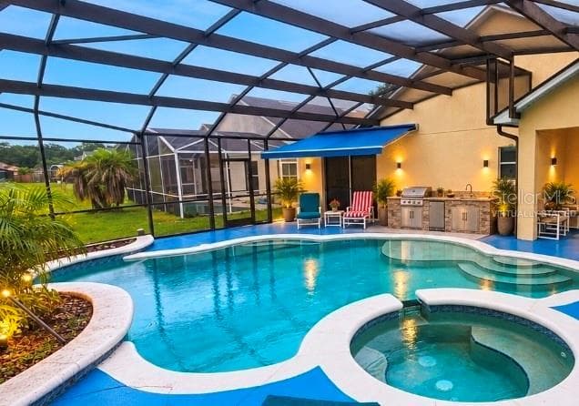 SUMMER KITCHEN AND AWNING OFF MASTER VIRTUALLY STAGED - 4640 EAGLE PEAK DR, KISSIMMEE