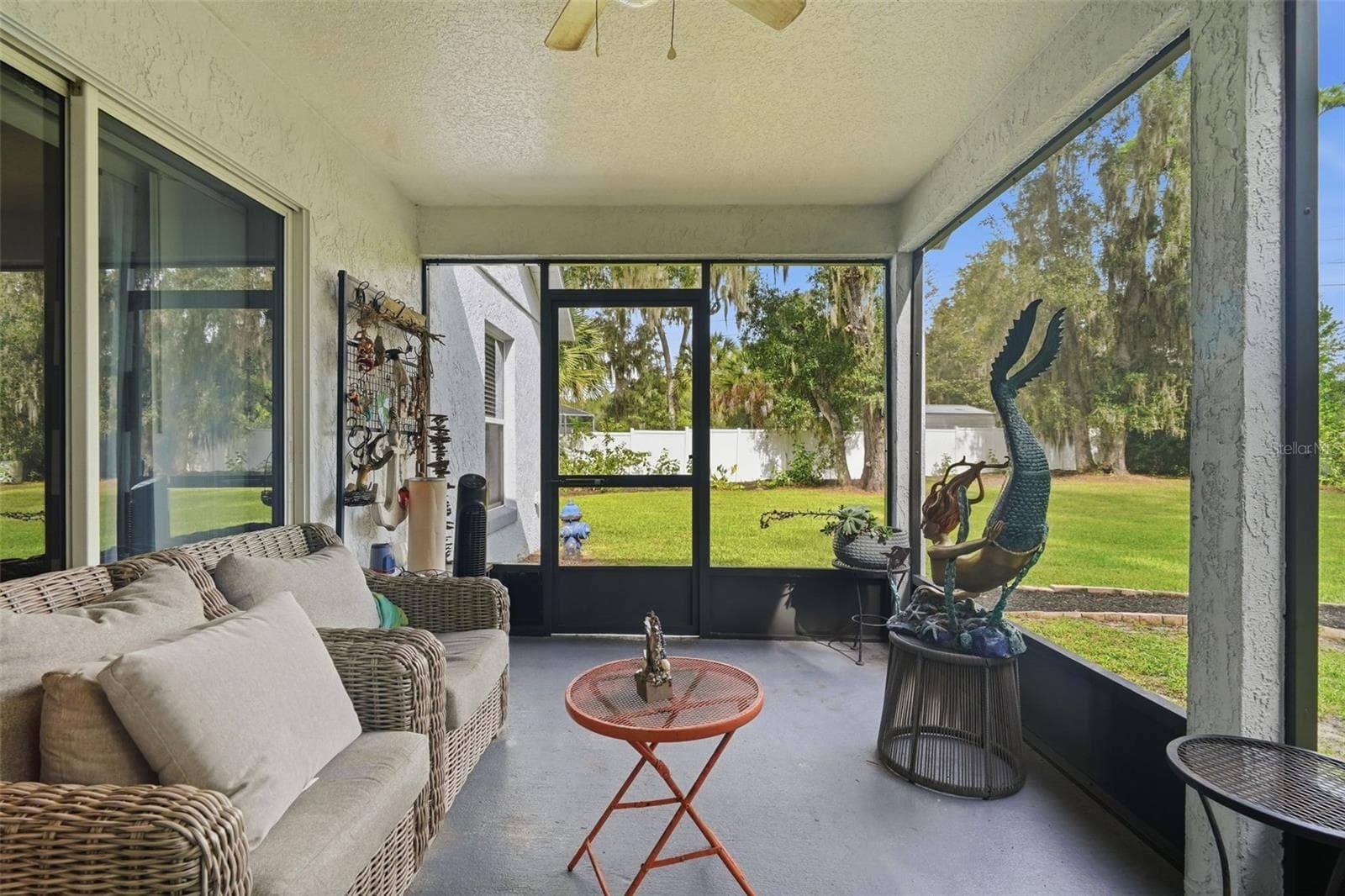 The large screened porch is the perfect place for enjoying life without the bugs. - 430 DEANNA CIR, DELAND