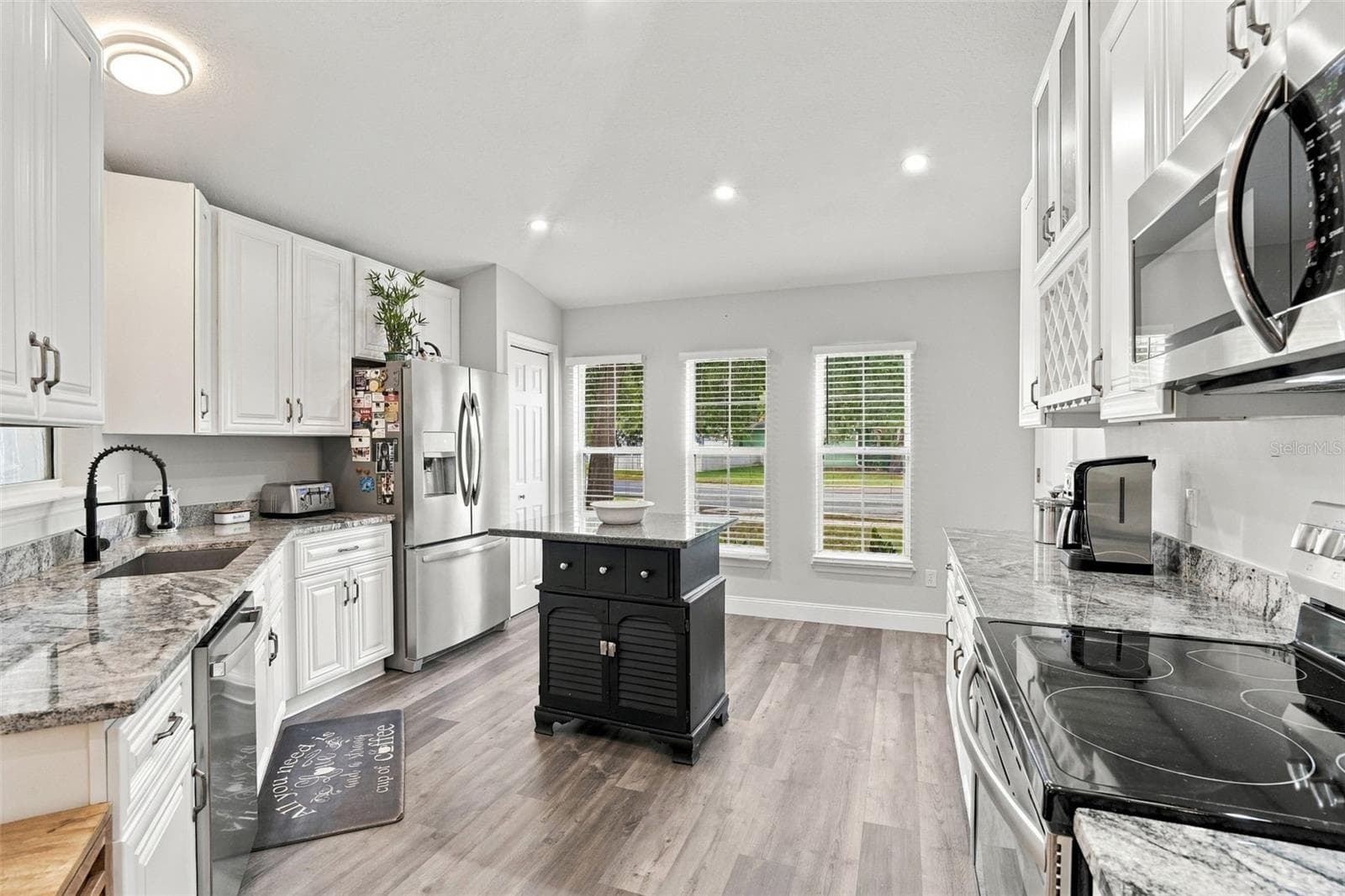 These gorgeous floors flow throughout this entire home. All appliances convey. - 430 DEANNA CIR, DELAND