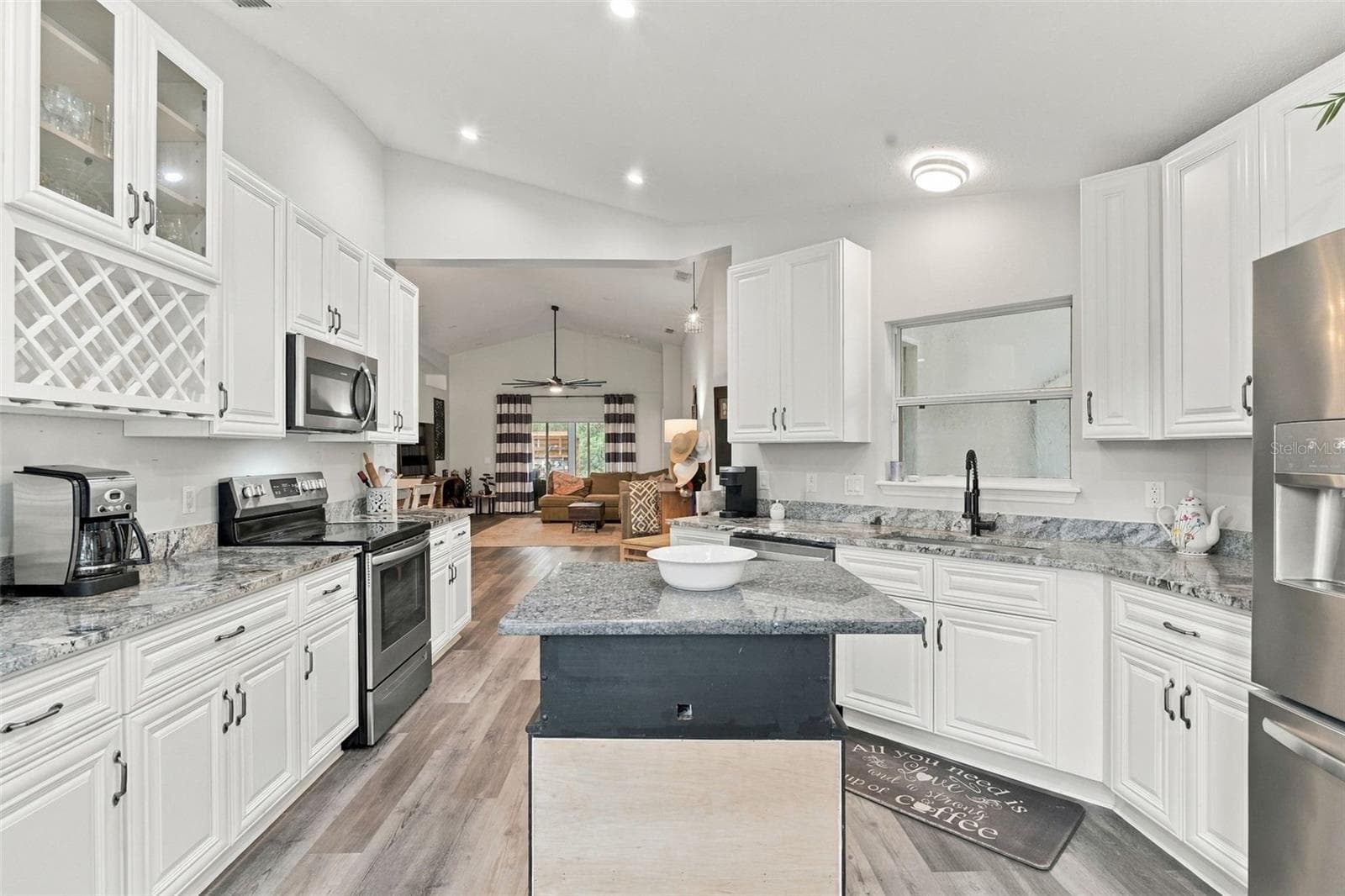 Kitchen from front windows. The lighting is beautiful! - 430 DEANNA CIR, DELAND
