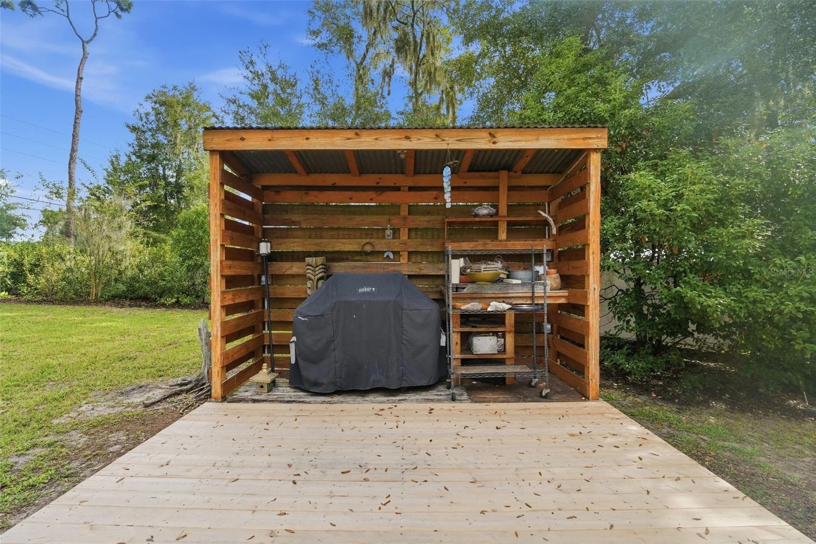 This barbecue patio in the fenced back yard is incredibly nice! - 430 DEANNA CIR, DELAND