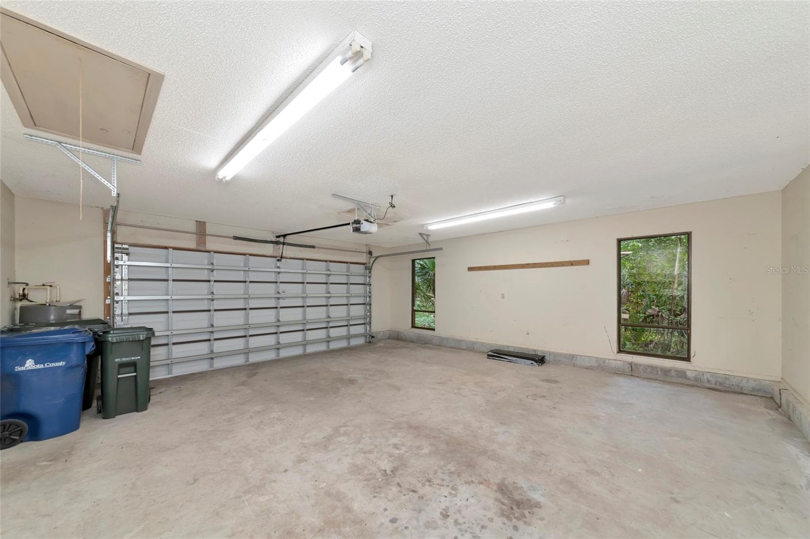 Large 2 Car Garage with 2 Windows and a Side Door. - 4781 STONE RIDGE TRL, SARASOTA
